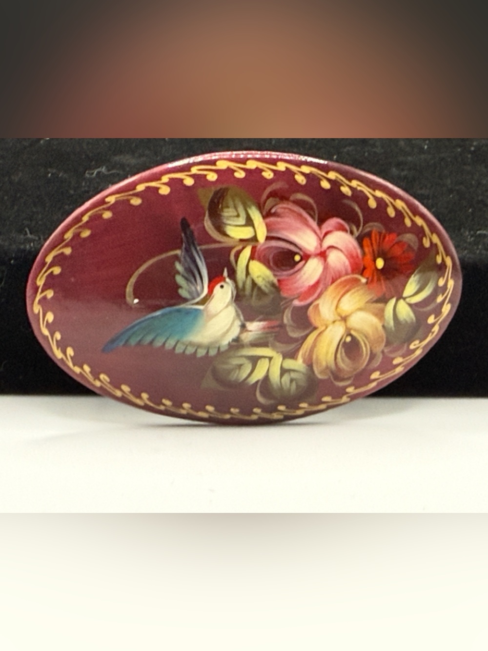 vintage Russian hand-painted lacquered wood brooch featuring a hummingbird among